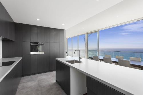an empty kitchen with a view of the ocean at Southpoint -Brand new home, oceanfront views in Wye River