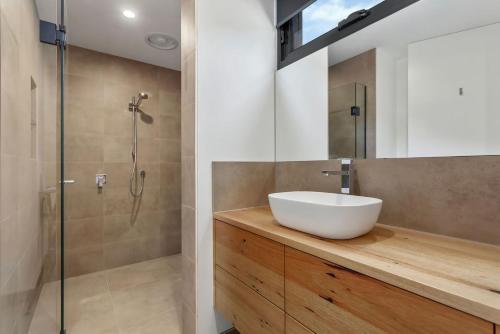 a bathroom with a sink and a shower at The Cube in Wye River