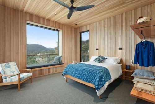a bedroom with a bed and a large window at At Wye Eyrie II in Wye River