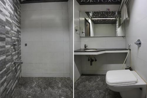 a bathroom with a toilet and a sink and a mirror at Hotel Shivani Residency - Mira Road in Mumbai