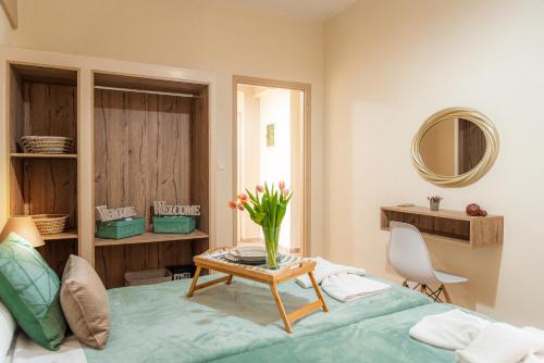 a bedroom with a bed and a table with a vase of flowers at Kavos Mamas Reas in Kavos