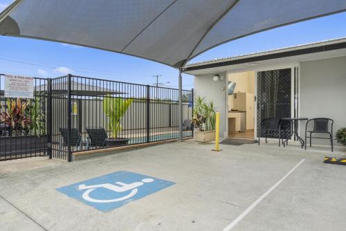 a parking lot with a handicapped sign on a patio at Caboolture Central Motor Inn, Sure Stay Collection by BW in Caboolture