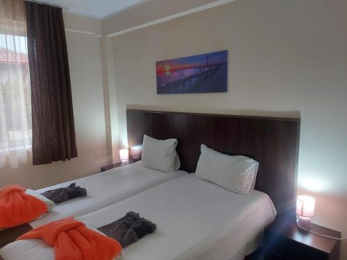 a hotel room with two beds and a window at Вилен комплекс Дарибел in Sapareva Banya