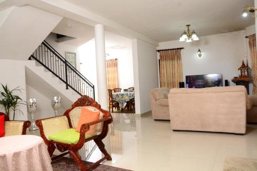 a living room with a couch and a chair at The Fern Inn in Nuwara Eliya