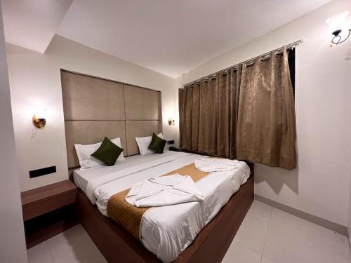 a bedroom with a large bed in a room at Hotel Grande Residency in Jaipur