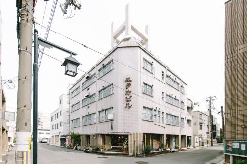 ein weißes Gebäude mit einem Kreuz darüber in der Unterkunft Guesthouse RICO in Wakayama