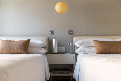 two beds sitting next to each other in a bedroom at Virgin Hotels Chicago in Chicago