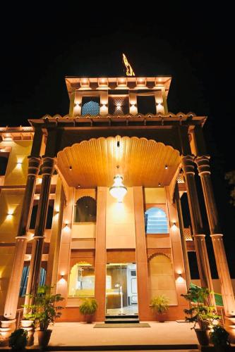 a large building with pillars and lights on it at Trimrooms Shubharambh Ayodhya in Ayodhya