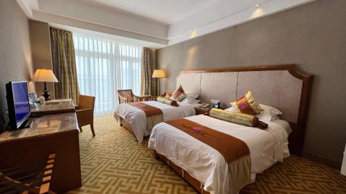 Wenchang Waika Hotel tesisinde bir odada yatak veya yataklar