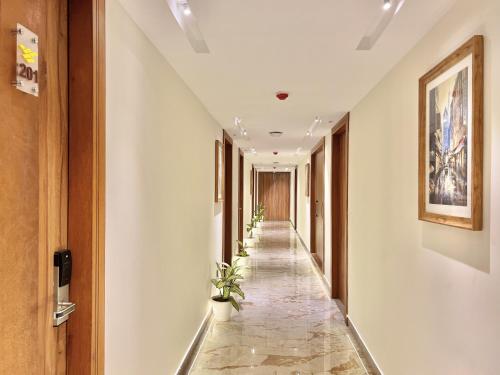 a corridor in a building with plants on the walls at SJ PARADISE in Dehradun
