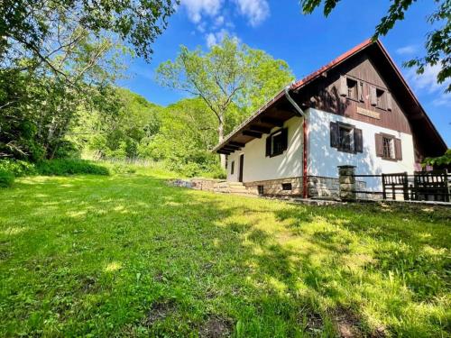 a barn with a green field in front of it at Holiday Home Marianne in Velké Svatoňovice