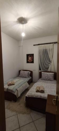 a bedroom with two beds and a ceiling fan at Villa Maria in Avdélla