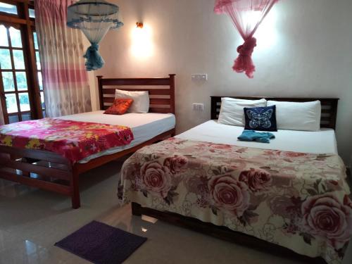 a bedroom with two beds and a window at Ella Sunrise in Ella