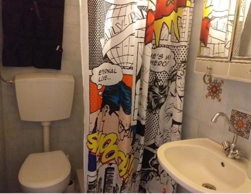 a bathroom with a toilet and a shower curtain at Cute home Zaros in Zarós