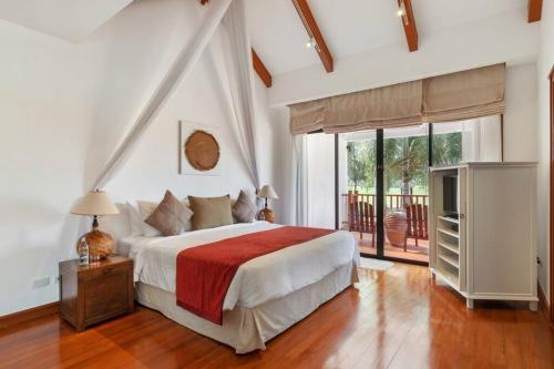 - une chambre avec un grand lit et une télévision dans l'établissement Laguna Fairway Villa, à Layan Beach