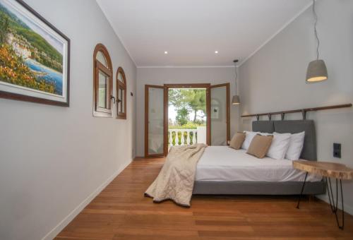 a bedroom with a large white bed and a table at Adriana di Levante by "elite" in Ayios Kirikos