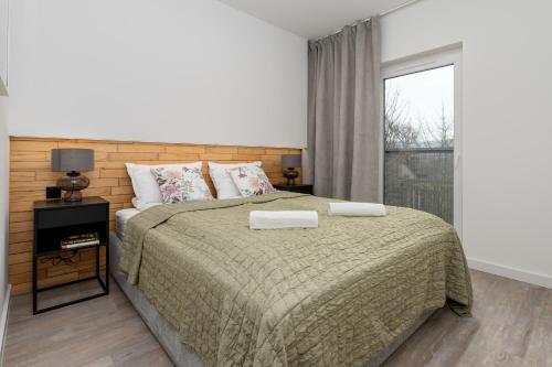 a bedroom with a large bed and a window at CityCenterApartments-11/19 in Bielsko-Biala