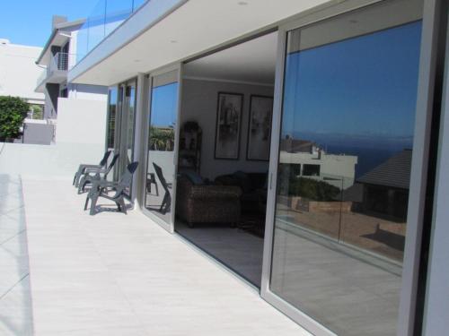 a balcony with sliding glass doors with a view of the ocean at 80 on Rodger in Linkside