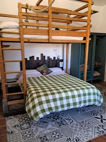 a bedroom with two bunk beds with a checkered bed at La Casona de la Luz in Guadix