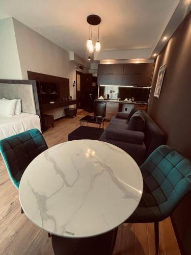 a living room with a table and a couch at Living Rooms in Skopje