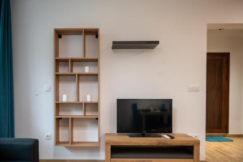 a living room with a tv and a coffee table at Modern and Cozy 1BDR Apartment in the City Center in Sofia