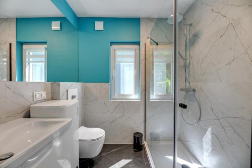 a bathroom with a white toilet and a shower at Soul Camp Nowęcin in Łeba