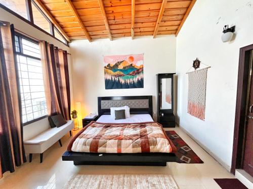 a bedroom with a bed and a couch at Meraki - Entire 3BHK Villa With Himalayan Views in Rānīkhet