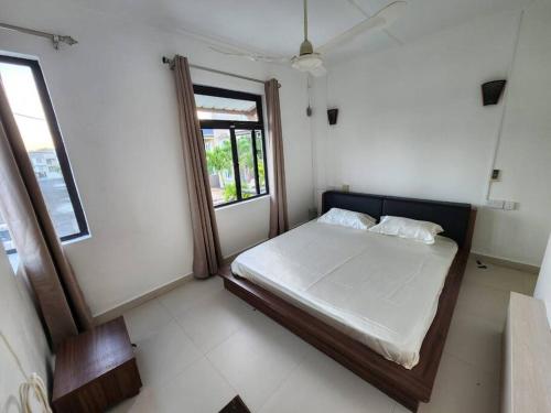 a small bedroom with a bed and a window at Le Choix- Zil in Grand-Baie