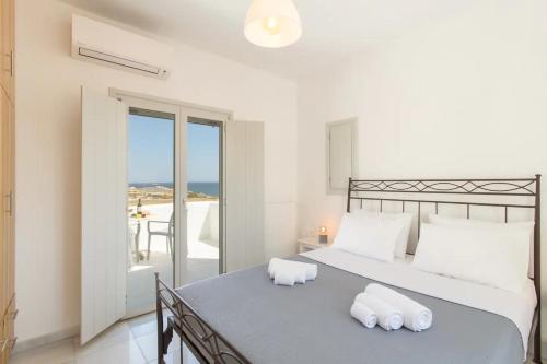 a bedroom with a bed with two pillows on it at Maisonette Sail in Naousa