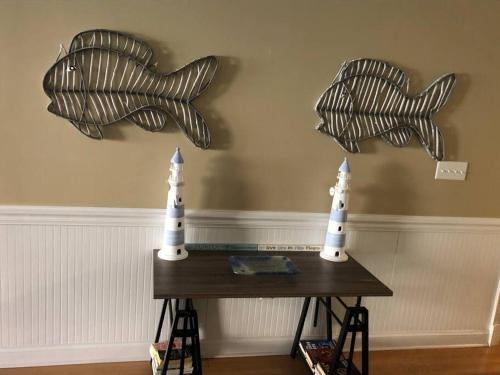 a table with two paper boats on the wall at Unique 3BR, 1 of 5 Condos w/Huge Poolside Patio, Steps to Beach & Pier, Gated in Tybee Island