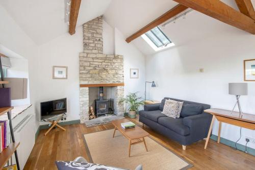 a living room with a couch and a fireplace at Perfect Getaway Close to Bath and Bristol in Bitton