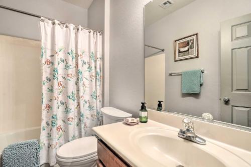 a bathroom with a sink and a toilet and a shower curtain at Fire Table, Grill Surprise Cottage with Pool Access in Surprise