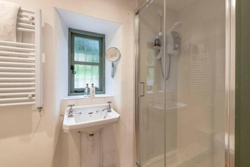 a white bathroom with a sink and a shower at Perfect Getaway Close to Bath and Bristol in Bitton