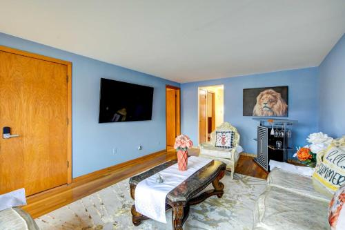a living room with blue walls and a tv at Oak Lawn Apartment about 2 Mi to Ford City Mall! in Oak Lawn