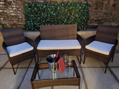 three chairs and a table with a red ribbon on it at Serene getaway Apartments in Maidstone