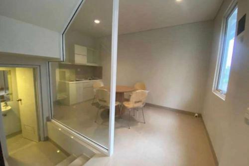 a room with a table and chairs and a window at EXPRESS O 92155 Nia Residence 2 in Tegal
