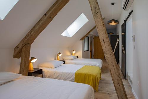1 dormitorio en el ático con 2 camas y tragaluz en La Renaissance, en Saint-Dyé-sur-Loire