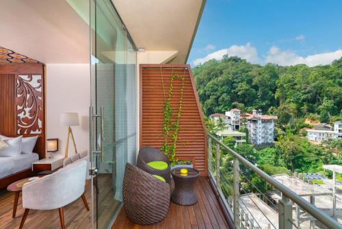 a room with a balcony with a view at Grand Serendib Hotel in Kandy