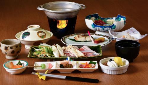 a table with plates of food and bowls of food at Sakahijiri Nikko in Nikko