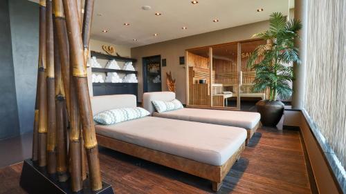 een kamer met 2 bedden met bamboestokken bij Van der Valk hotel Veenendaal in Veenendaal