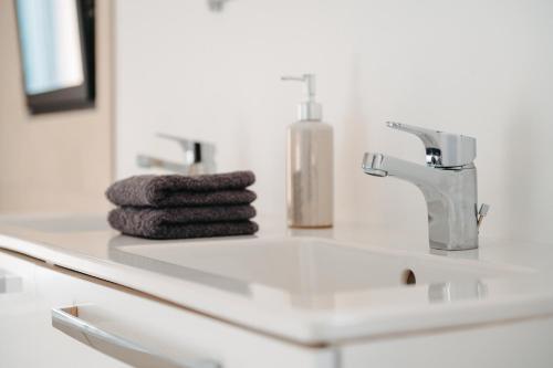 a bathroom counter with a sink and a towel at Villa Terrasse et Piscine à l'entrée de Porticcio in Cauro