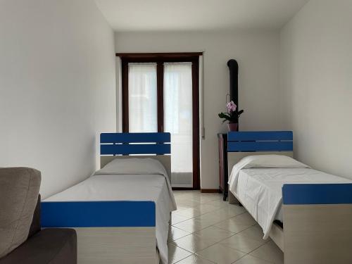 Una cama o camas en una habitación de Appartamento tranquillo con vista montagna