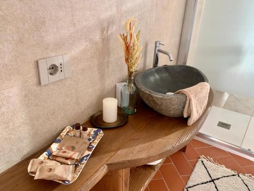 a bathroom with a sink on a wooden table at Agriturismo Il Colle in Poggio Alla Croce