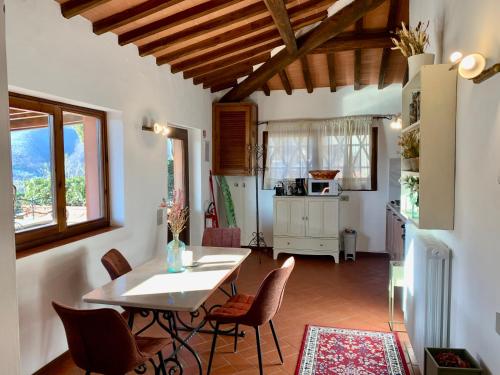 a kitchen and dining room with a table and chairs at Agriturismo Il Colle in Poggio Alla Croce