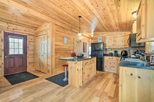 a kitchen with wooden walls and a wooden floor at Cozy Cabin in Parsons Hike, Fish and Explore! in Parsons