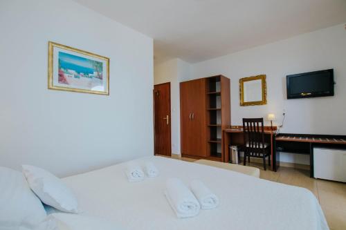 Postel nebo postele na pokoji v ubytování Hotel Vila Tina