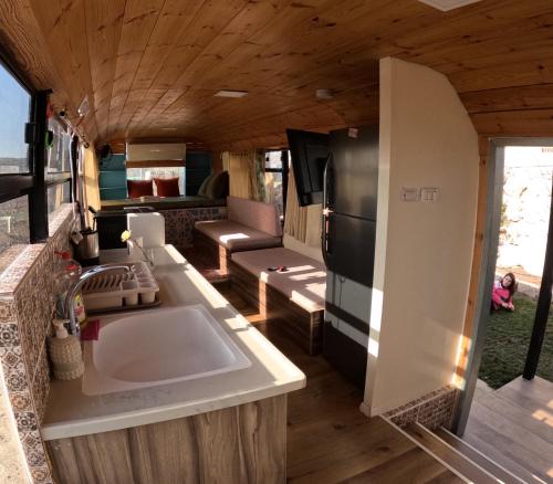 a kitchen and living room of an rv at The Bus in Majdal Shams
