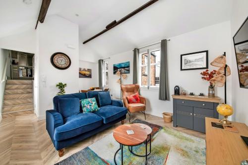 a living room with a blue couch and a table at Finest Retreats - The Bank House in Boroughbridge