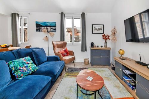 a living room with a blue couch and a table at Finest Retreats - The Bank House in Boroughbridge