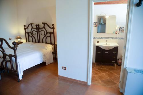 a bedroom with a bed and a sink at Dimora Santa Barbara in Matera